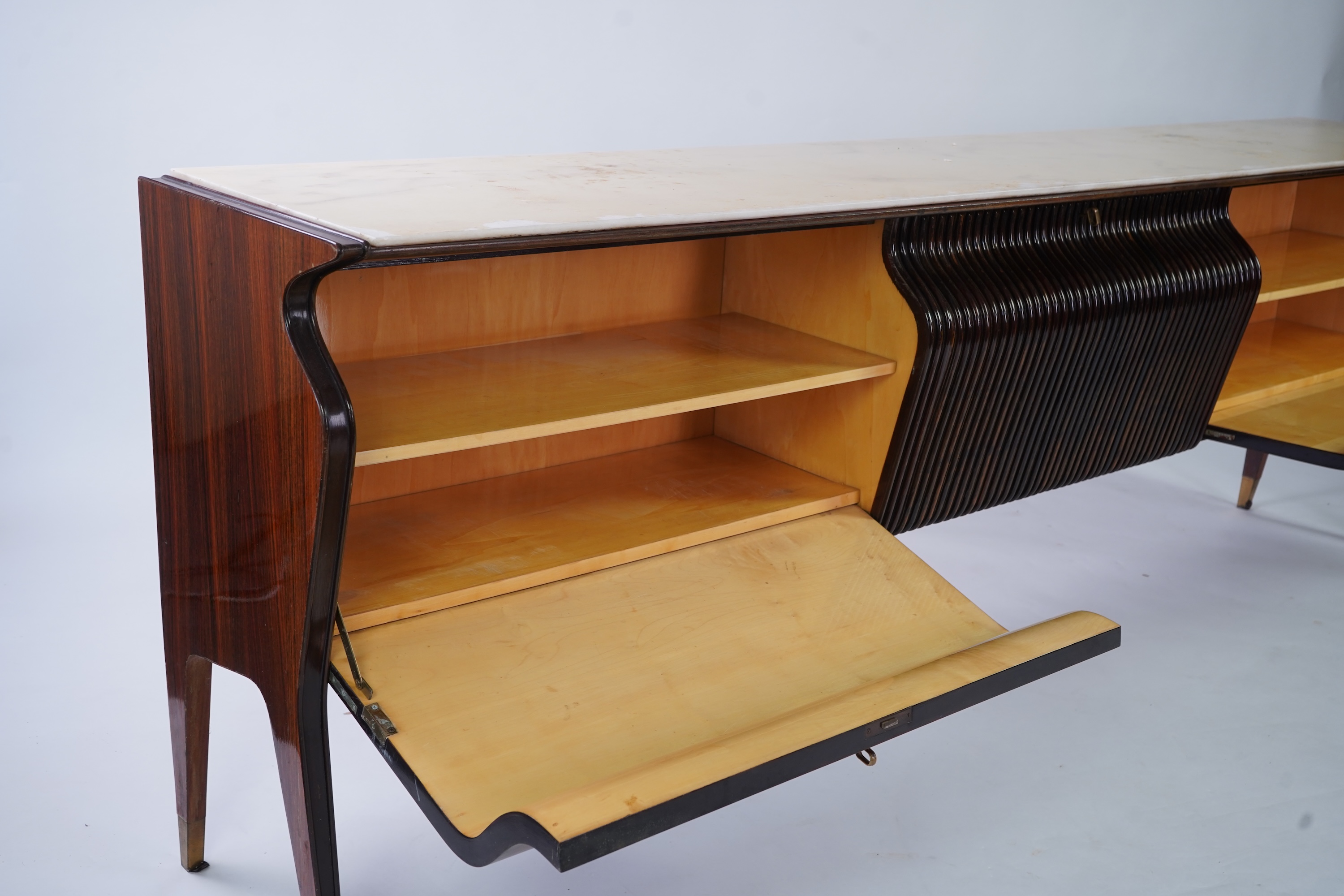 Osvaldo Borsani (Italian, 1911-1985) for Atelier Borsani Varedo: A large Indian rosewood and mahogany credenza, 276.5cm wide x 49cm deep x 94cm high